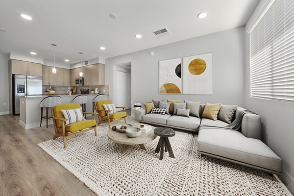 Spacious living room featuring cozy seating and large windows in Album Marana Apartments, luxury living near vibrant Tucson
