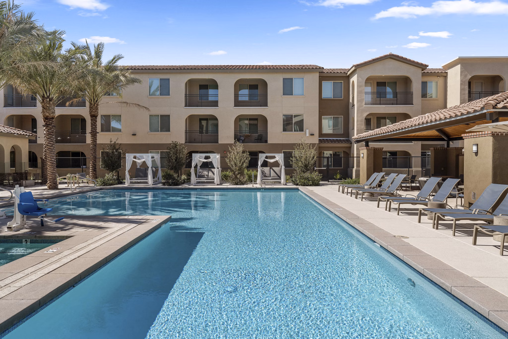 Outdoor pool with seating area at Album Marana Apartments, luxury community in serene Marana setting