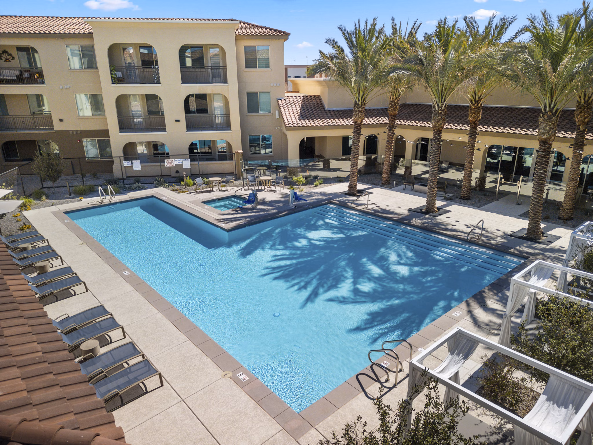 Amenity Template: Resort-style pool with lounge chairs at Album Marana Apartments
