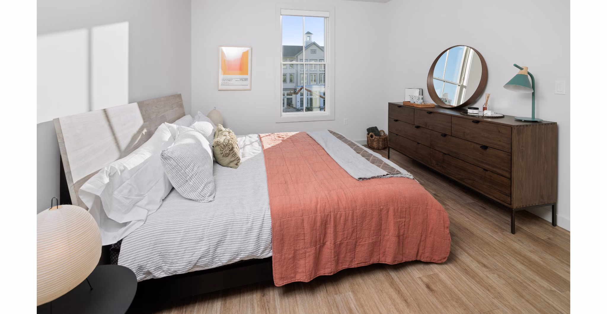 Cozy bedroom with contemporary design and large windows at Darien Commons Apartments