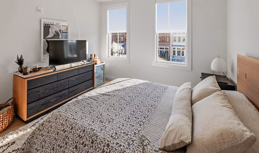 Cozy bedroom with contemporary decor at Darien Commons Apartments: luxury living with stylish amenities