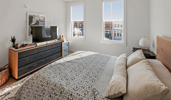 Cozy bedroom with contemporary decor at Darien Commons Apartments: luxury living with stylish amenities