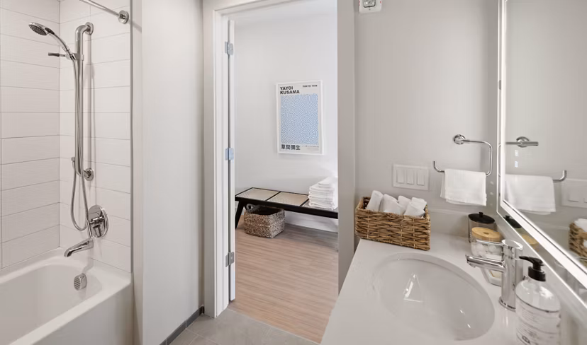 Bathroom featuring modern fixtures and elegant lighting at Darien Commons Apartments