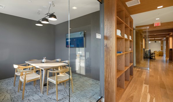 Modern clubhouse with cozy seating areas at Darien Commons Apartments, offering luxury living and community events in a stylish setting