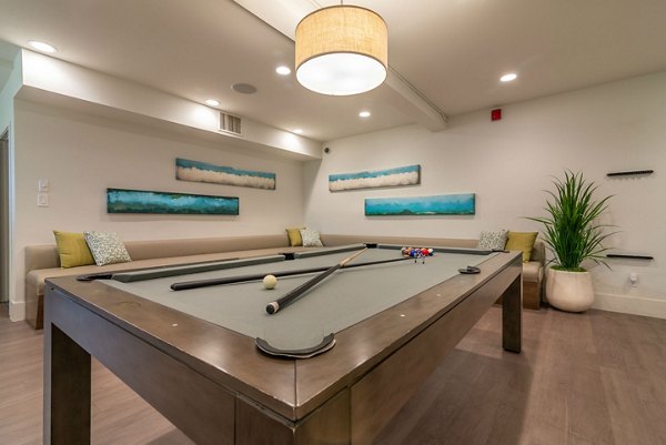 Game room with billiards and seating at Towne at Glendale Apartments, offering luxury leisure spaces for residents