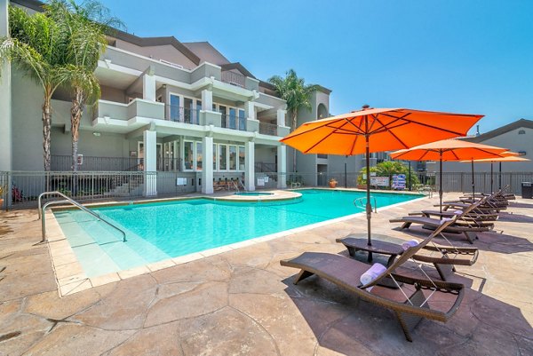 Relaxing poolside oasis at Towne at Glendale Apartments featuring luxury seating and lush landscaping