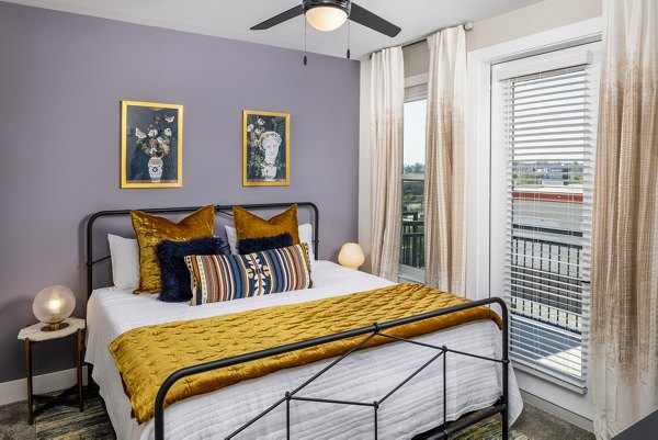 Luxurious bedroom with ample natural light at Broadstone SoBro Apartments, featuring premium furnishings and modern amenities for comfortable living