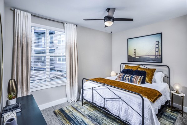 Elegant bedroom featuring a king-size bed and modern decor at Broadstone SoBro Apartments