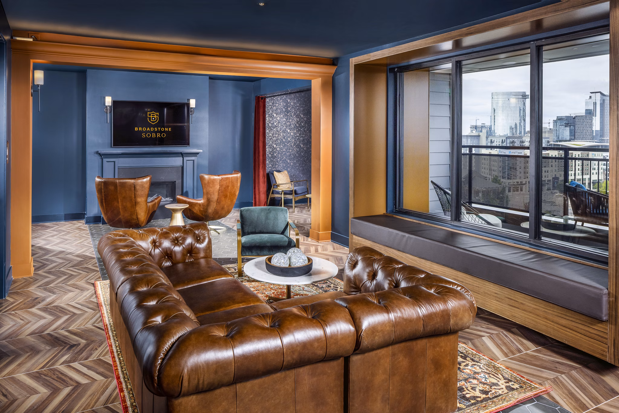 Clubhouse lobby featuring modern decor and seating at Broadstone SoBro Apartments
