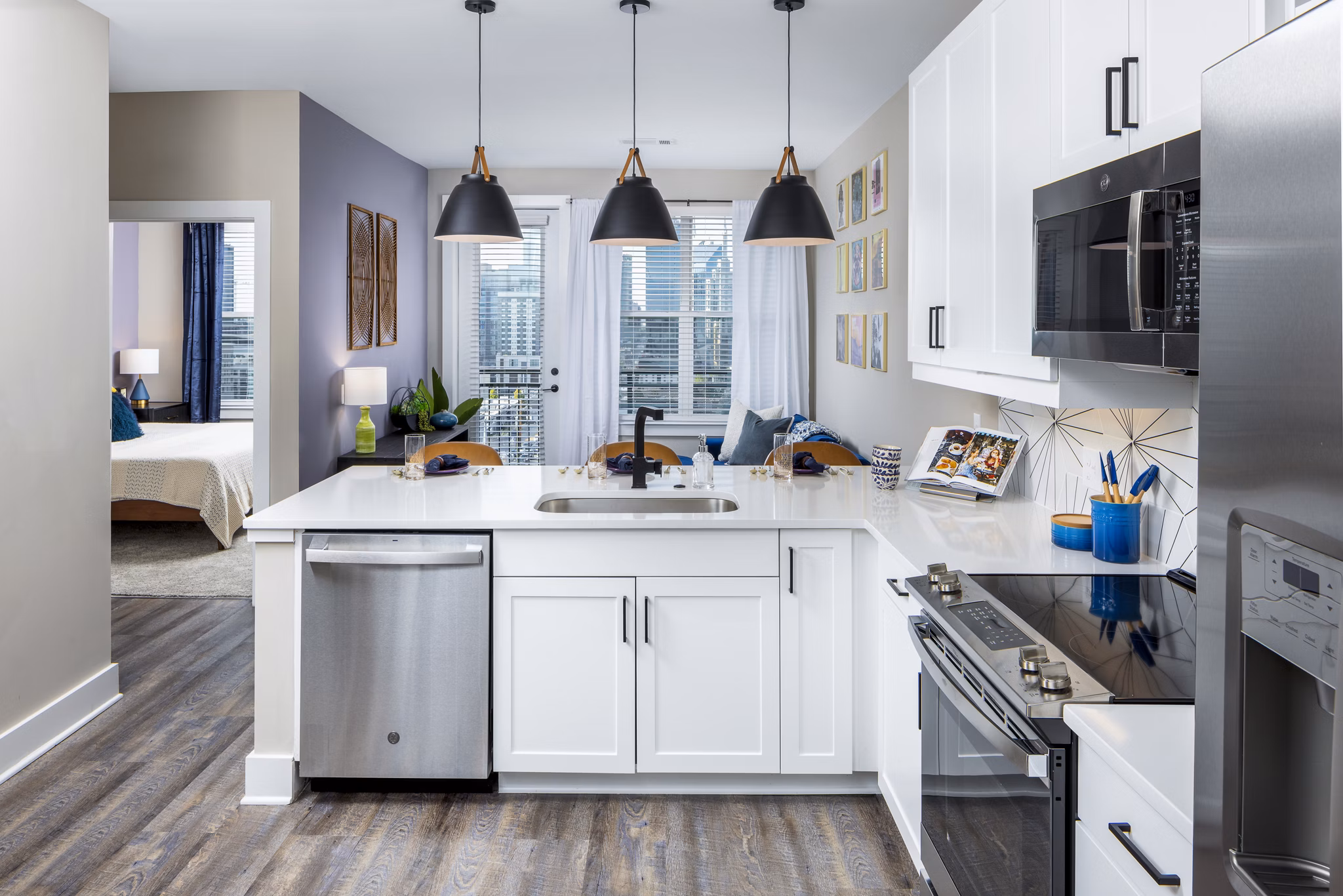 Modern kitchen with stainless steel appliances and marble countertops at Broadstone SoBro Apartments