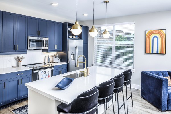 Contemporary kitchen featuring sleek countertops and modern appliances at Broadstone SoBro Apartments