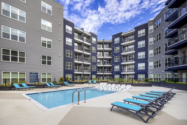 Poolside luxury at Broadstone SoBro Apartments: inviting outdoor pool with lounge chairs in vibrant downtown Nashville setting