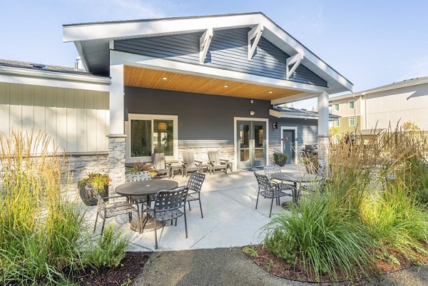 Patio with outdoor seating and greenery at Park on 20th Apartments, highlighting relaxing outdoor living spaces in this luxury community in Lake Stevens, WA.