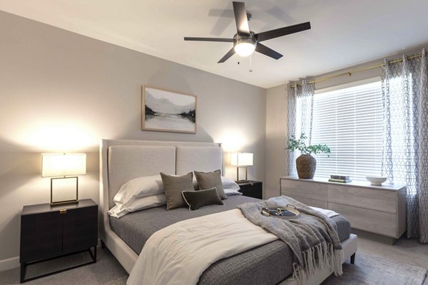 Cozy bedroom featuring contemporary decor at Avenida at Centerra Apartments