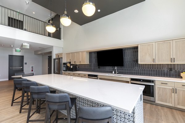 Clubhouse featuring modern design and seating areas at Avenida at Centerra Apartments in a luxury Greystar community