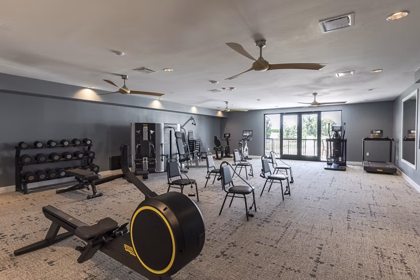 State-of-the-art fitness center at Avenida at Centerra Apartments featuring modern exercise equipment and spacious workout areas