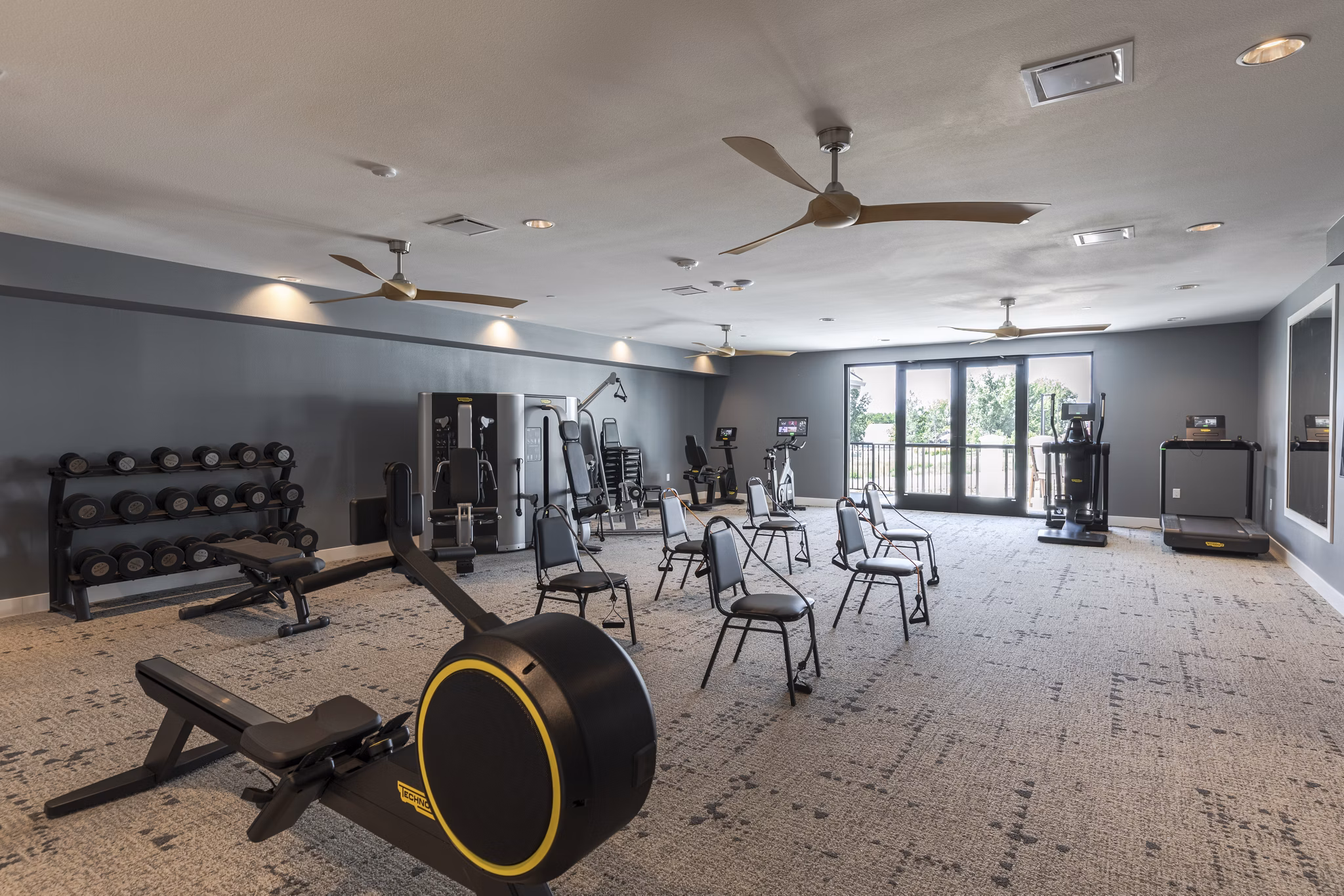 State-of-the-art fitness center at Avenida at Centerra Apartments featuring modern exercise equipment and spacious workout areas