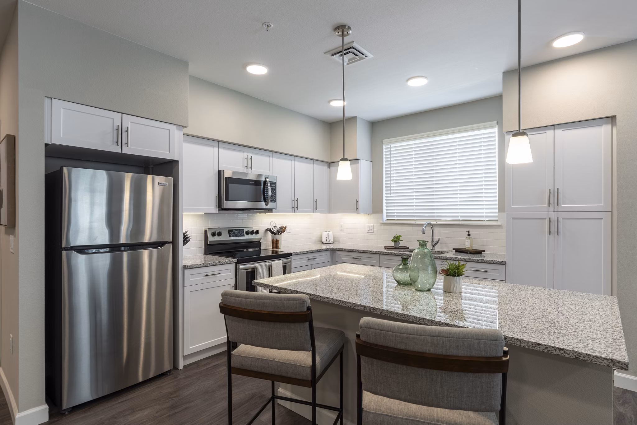 Modern kitchen with stainless steel appliances in Avenida at Centerra Apartments