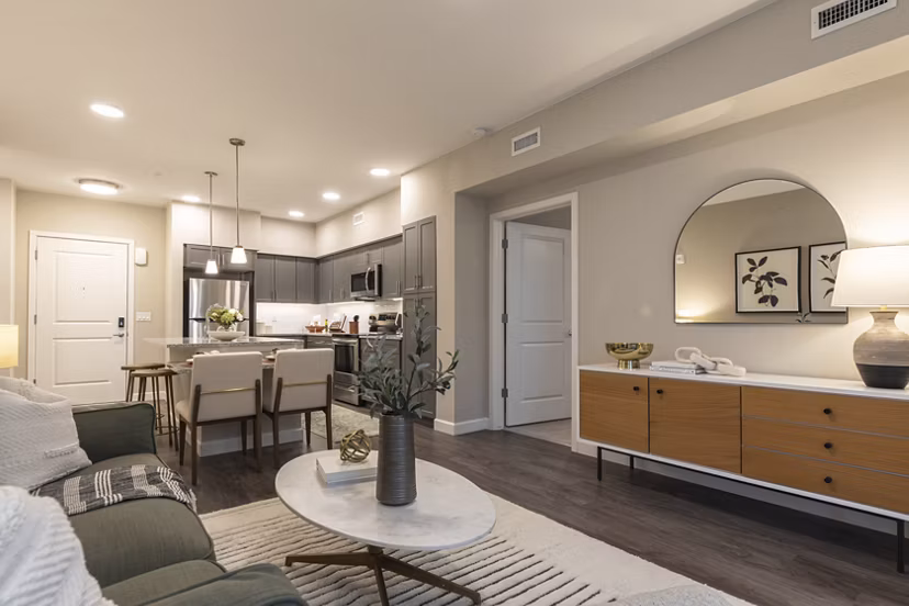 Contemporary living room with stylish decor and large windows at Avenida at Centerra Apartments, offering luxury living spaces