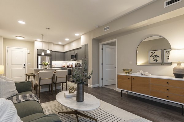 Contemporary living room with stylish decor and large windows at Avenida at Centerra Apartments, offering luxury living spaces