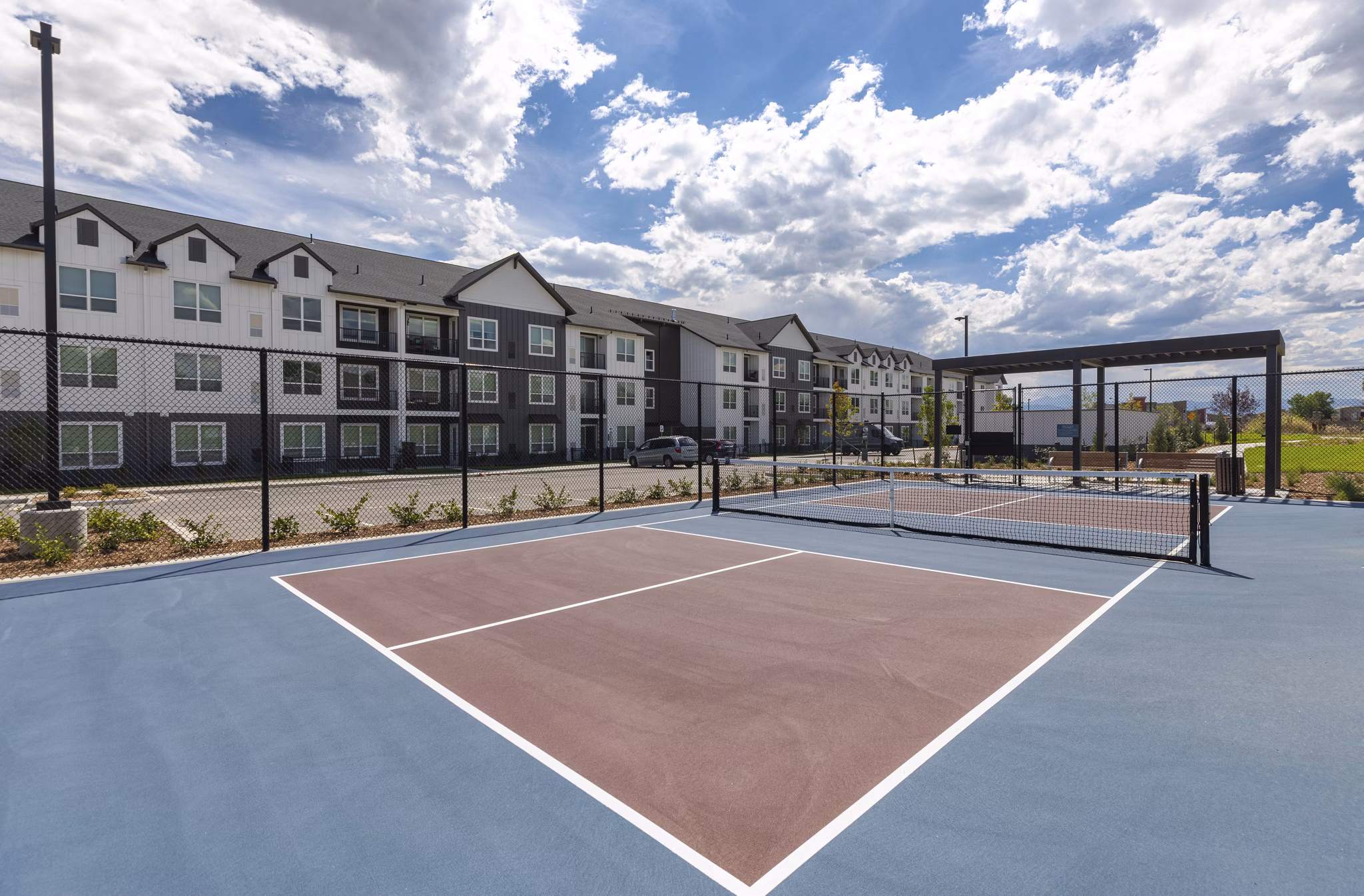 Outdoor sport court at Avenida at Centerra Apartments for recreational activities and fitness enthusiasts