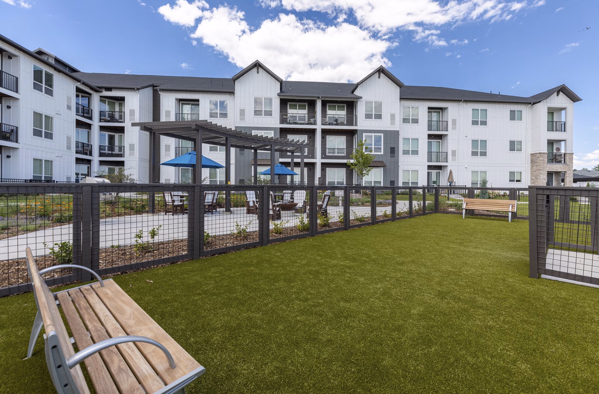 Dog park with agility equipment at Avenida at Centerra Apartments for pet-friendly living options