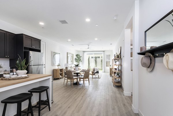 Kitchen featuring modern appliances and granite countertops in Vello Valley BTR Single Apartment Townhomes