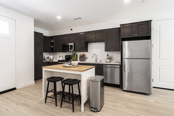 Open-concept kitchen with sleek countertops at Vello Valley BTR Single Apartment Townhomes