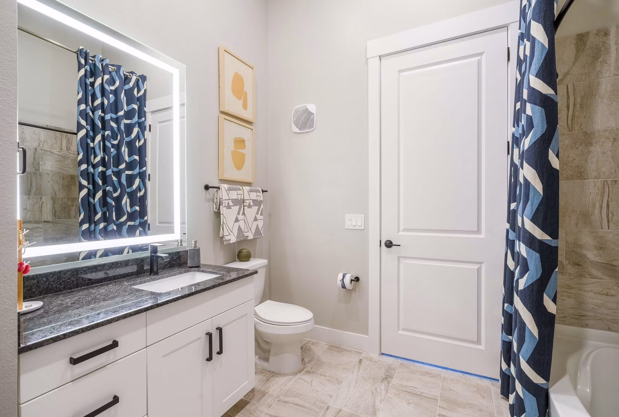 Bathroom featuring modern fixtures and elegant tiling at Cadence at Frisco Station Apartments