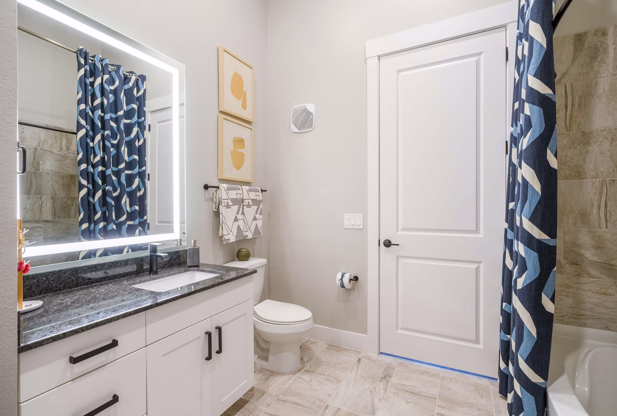 Bathroom featuring modern fixtures and elegant tiling at Cadence at Frisco Station Apartments