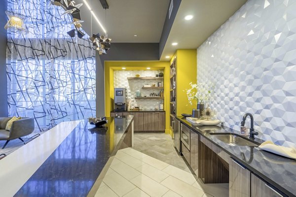 Modern clubhouse with sleek design at Cadence at Frisco Station Apartments, featuring comfortable seating and entertainment areas