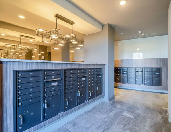 Mail room with secure package lockers at Cadence at Frisco Station Apartments