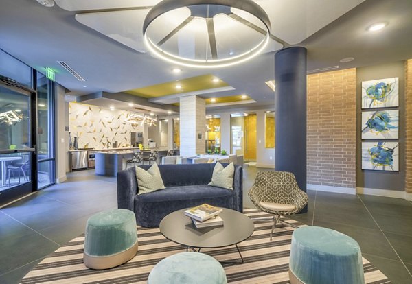 Stylish clubhouse with modern seating and entertainment options at Cadence at Frisco Station Apartments