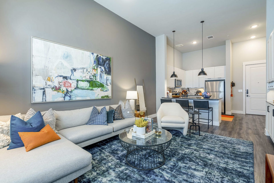 Spacious living room with modern furnishings in Cadence at Frisco Station Apartments