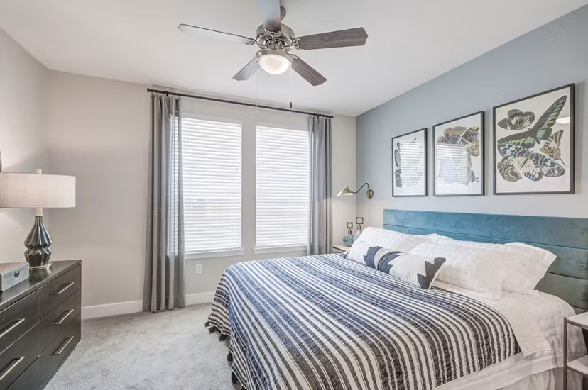 Cozy bedroom with modern decor at The Link at Twin Creeks Apartments