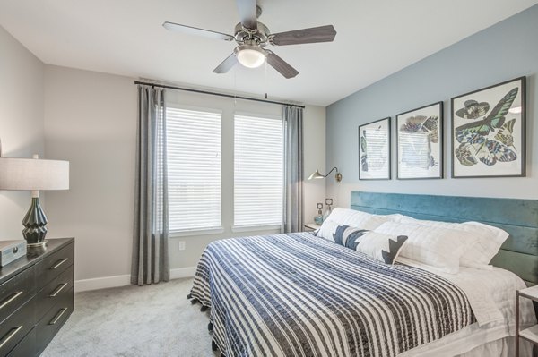 Cozy bedroom with modern decor at The Link at Twin Creeks Apartments