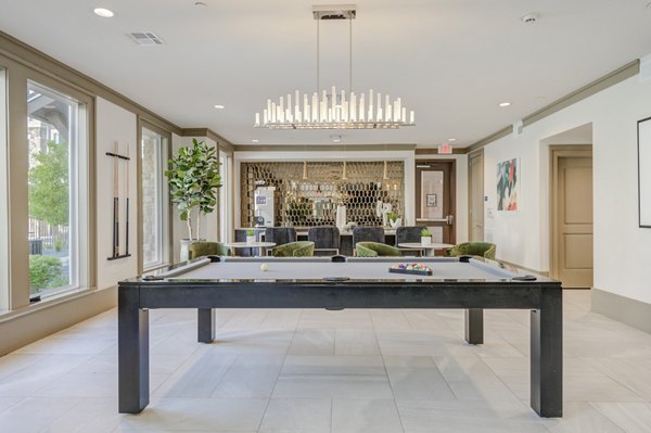 Vibrant game room with billiards and arcade games at The Link at Twin Creeks Apartments