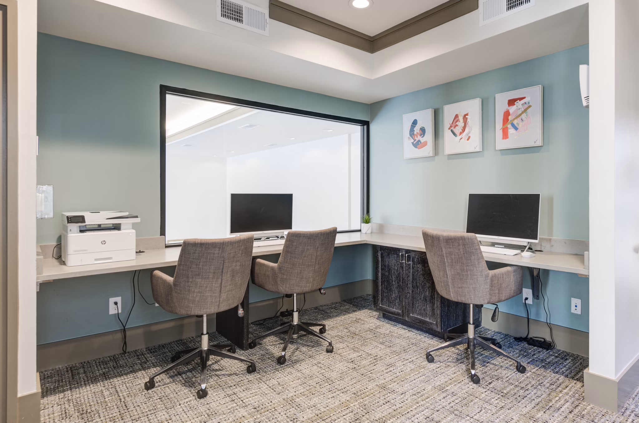 Modern business center with sleek workstations at The Link at Twin Creeks Apartments, ideal for remote work and collaborative projects