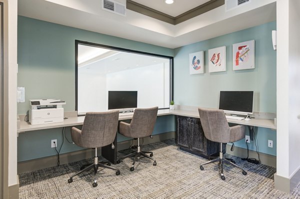 Modern business center with sleek workstations at The Link at Twin Creeks Apartments, ideal for remote work and collaborative projects