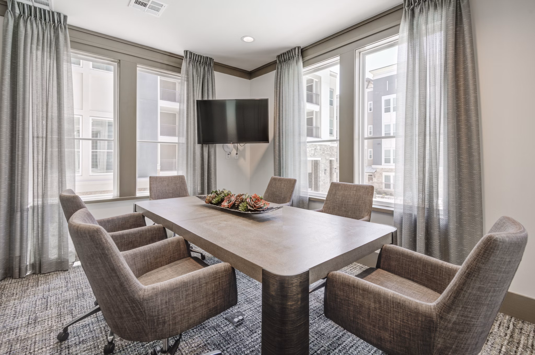 Meeting facility with modern conference table at The Link at Twin Creeks Apartments, ideal for gatherings and events