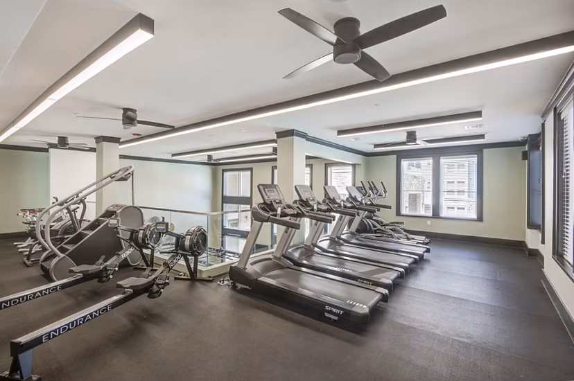 State-of-the-art fitness center with modern equipment at The Link at Twin Creeks Apartments Stay active and fit in a luxury setting