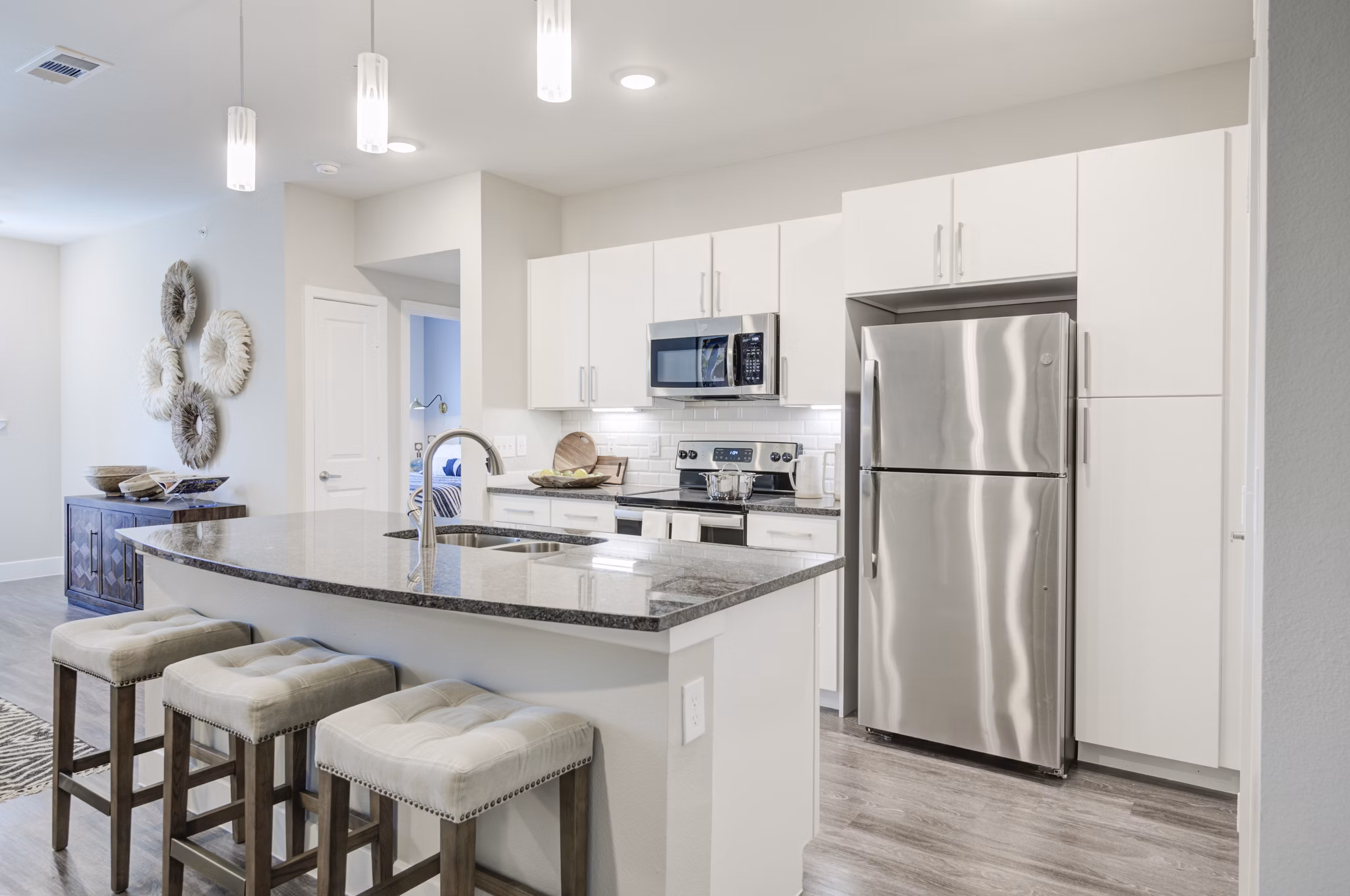 Modern kitchen with stainless steel appliances at The Link at Twin Creeks Apartments