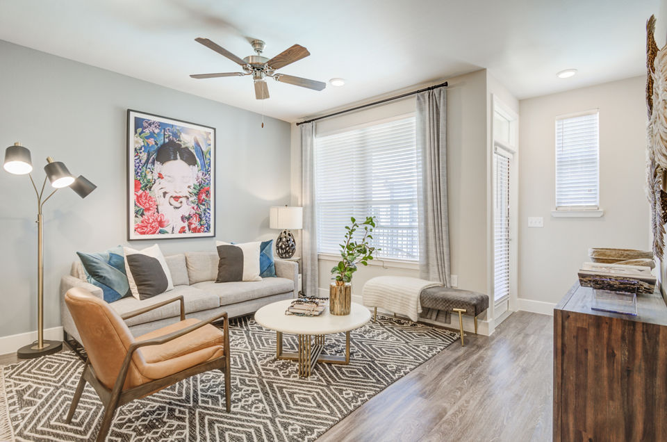 Spacious living room with modern decor in The Link at Twin Creeks Apartments