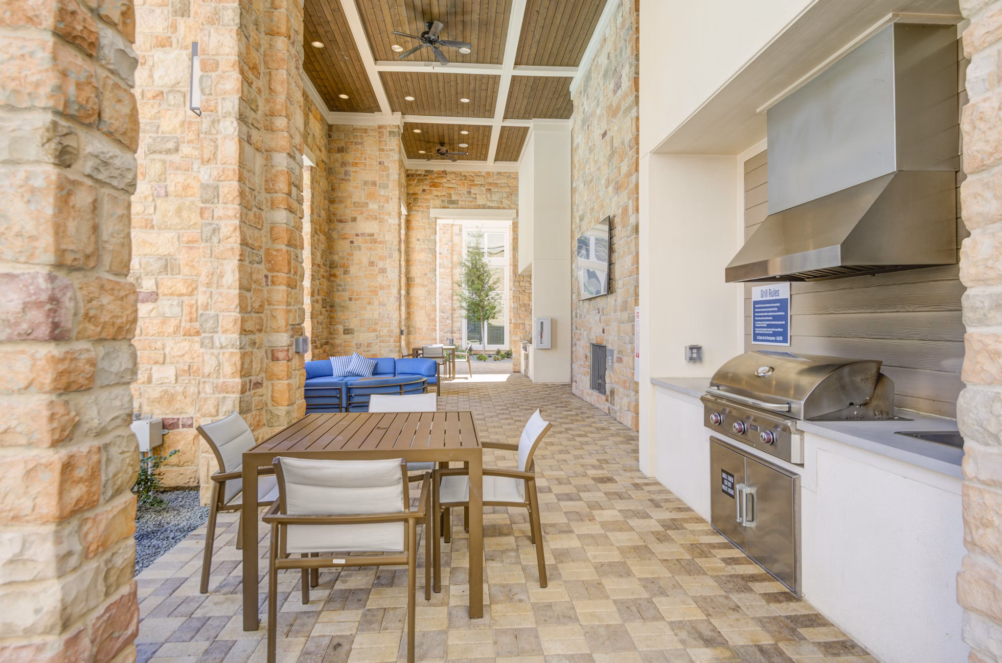 Grill area with modern outdoor seating at The Link at Twin Creeks Apartments, a luxury community offering premier amenities for residents