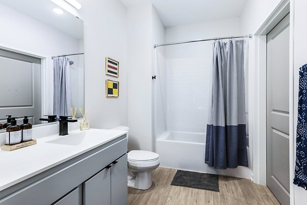Bathroom featuring contemporary design and sleek finishes at Beyond Woodbury Apartments