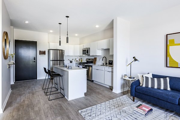 Modern kitchen with stainless steel appliances and granite countertops at Beyond Woodbury Apartments