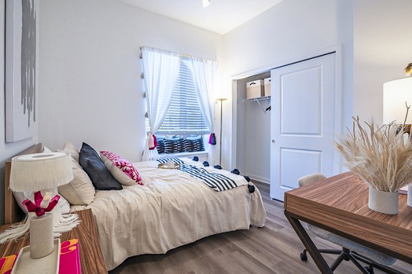 Cozy bedroom with modern furnishings at The Accolade Collegiate Village West Apartments