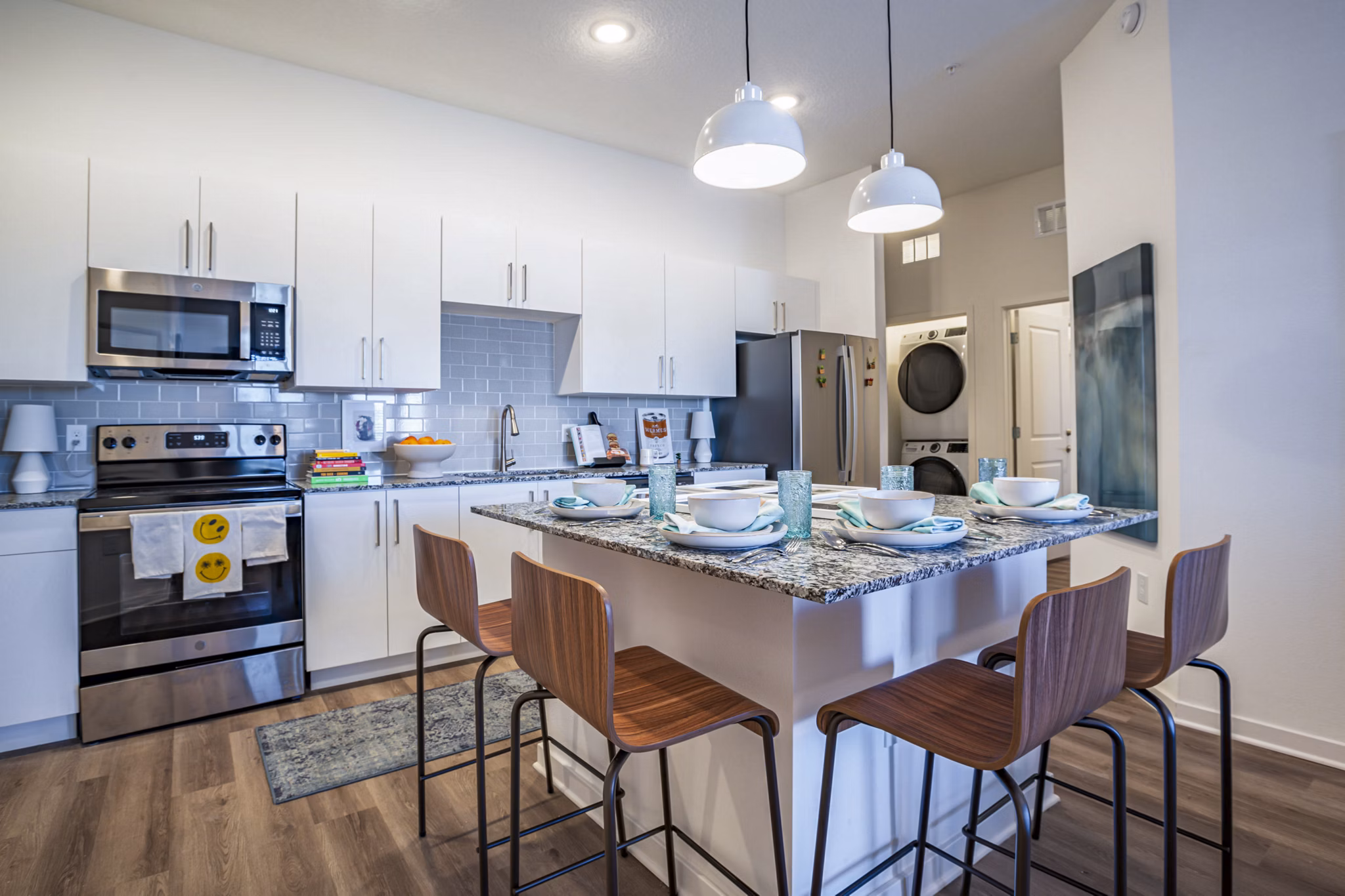 Dining room and kitchen featuring modern appliances at The Accolade Collegiate Village West Apartments