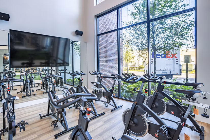 Yoga and spin studio with modern equipment at The Accolade Collegiate Village West Apartments