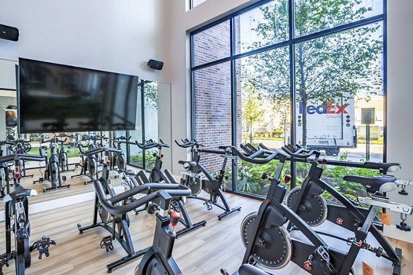 Yoga and spin studio with modern equipment at The Accolade Collegiate Village West Apartments